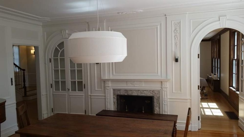 A beautifully repainted dining room with a sophisticated color scheme that adds elegance and warmth, painted by Impeccable Painting.