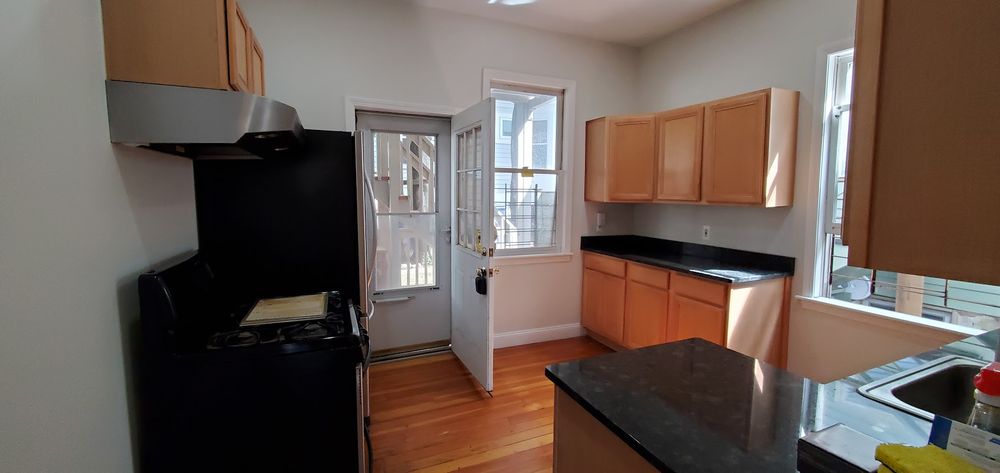 A freshly painted kitchen with vibrant, modern colors and a clean, refreshed look after being updated by Impeccable Painting.