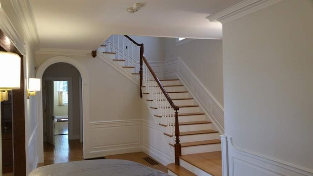 A freshly repainted entryway with a welcoming color scheme, enhancing the first impression of the home, painted by Impeccable Painting.